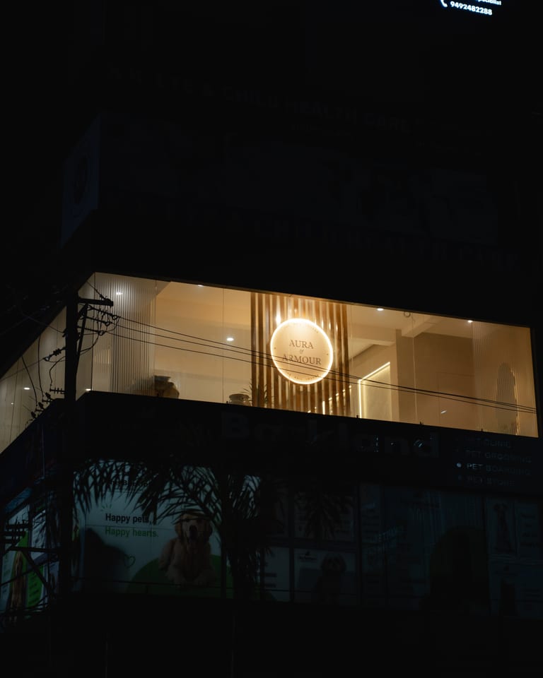 Circular sign lit in the second floor window at night