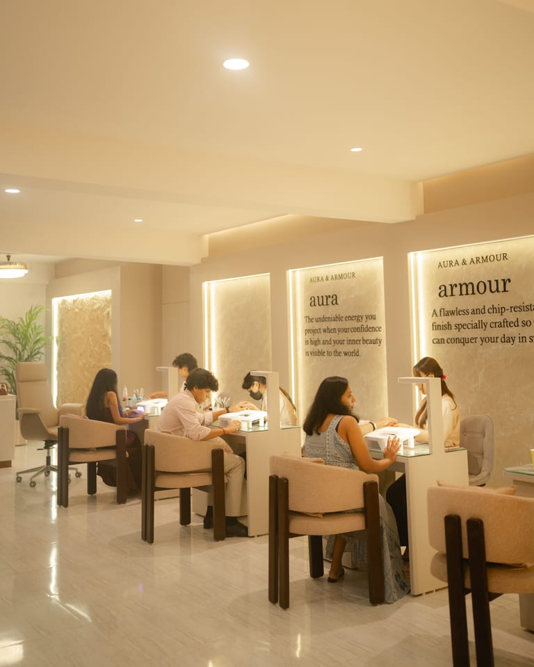 Clients seated at manicure stations receiving nail services